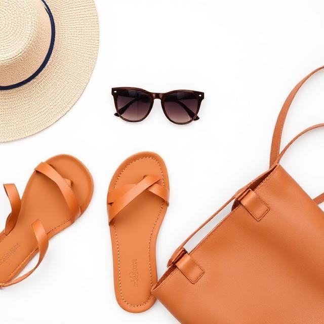 Flat lay of tan Miller sandals with sunglasses and a tote bag