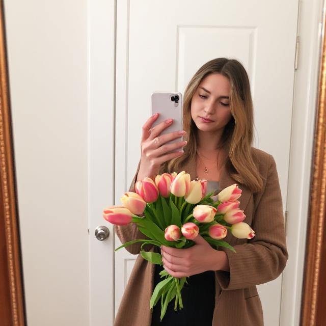 Outfit mirror selfie with fresh tulips in hand